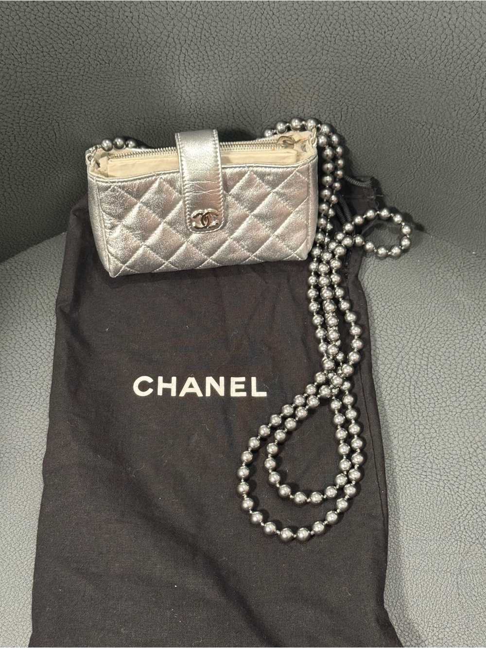 CHANEL Silver Quilted Leather O-Phone Holder with Pearl Chain.